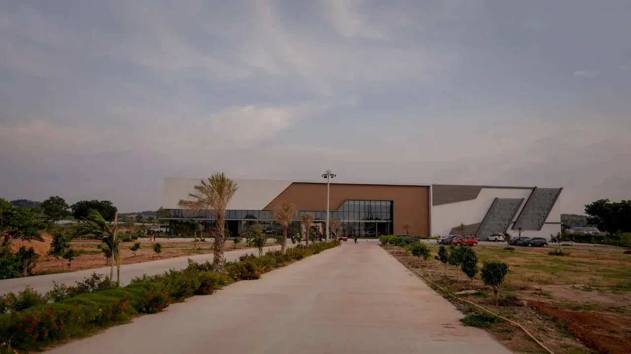 Long landscaped driveway leading to Nidhee Convention Centre