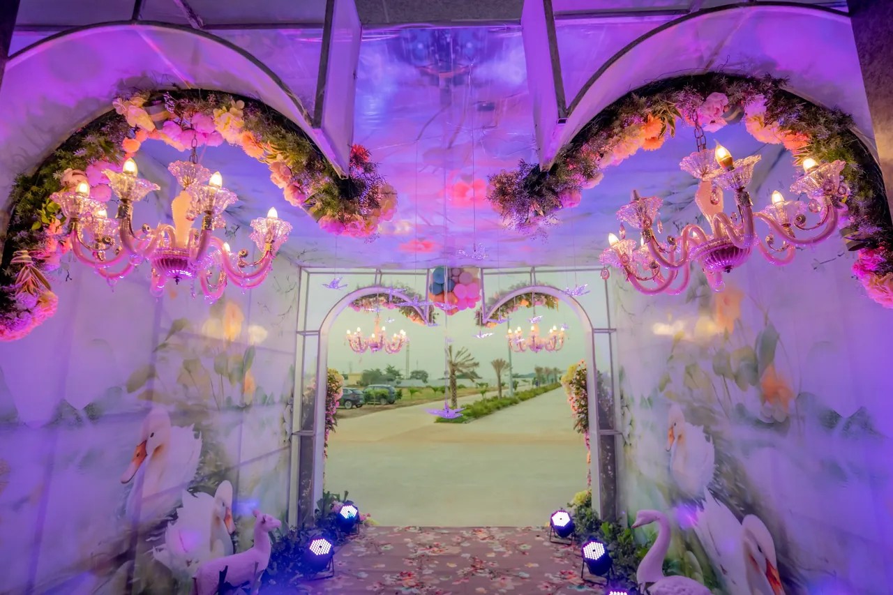 Illuminated floral passage leading from the hall to the landscaped drive