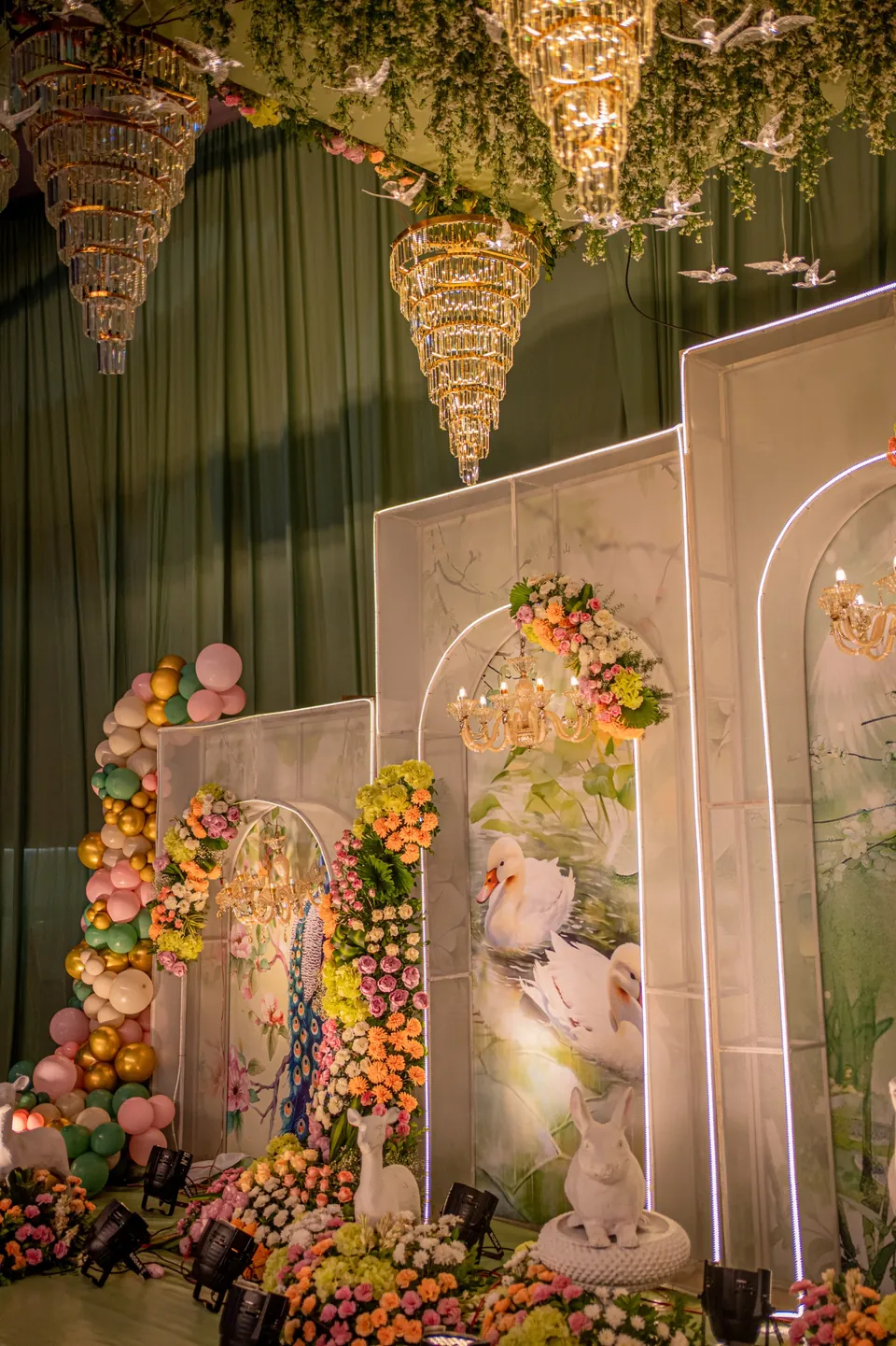 Floral stage detail with chandeliers and sculptural décor