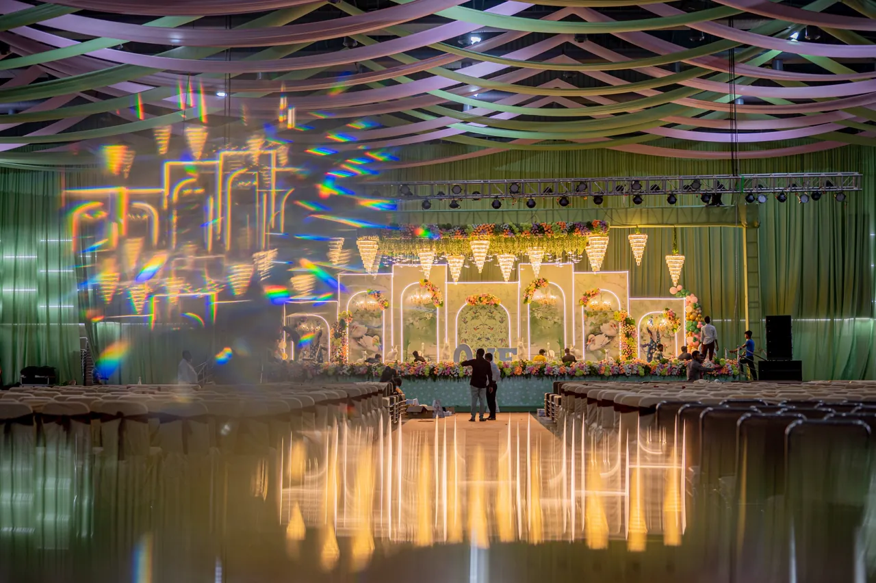 Decorated stage reflected across the polished grand hall floor