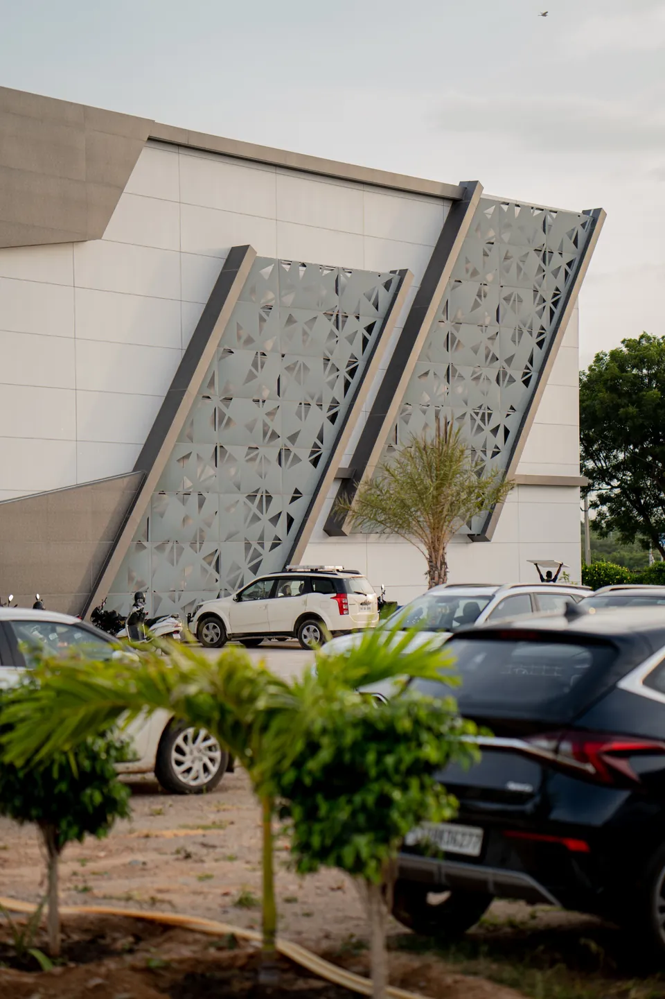 Open sky above the landscaped exterior of Nidhee Convention Centre